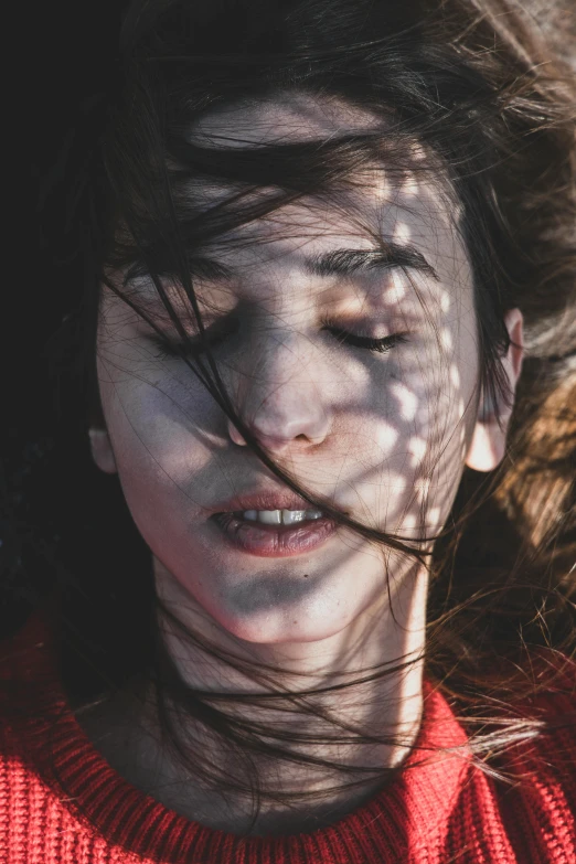 a woman with her hair blowing in the wind, inspired by Elsa Bleda, pexels contest winner, conceptual art, high angle closeup portrait, exhausted face close up, human face with bright red yes, brunette woman