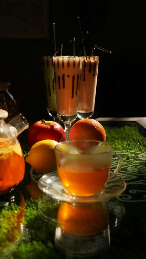 an assortment of drinks sitting on top of a table, a still life, inspired by Wlodzimierz Tetmajer, pexels, apple orange, square, tea, (night)