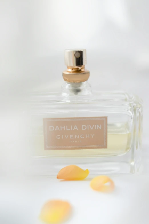 a bottle of perfume sitting on top of a table, by Daniel Gelon, divinity detailed, light blush, olivia, medium close up