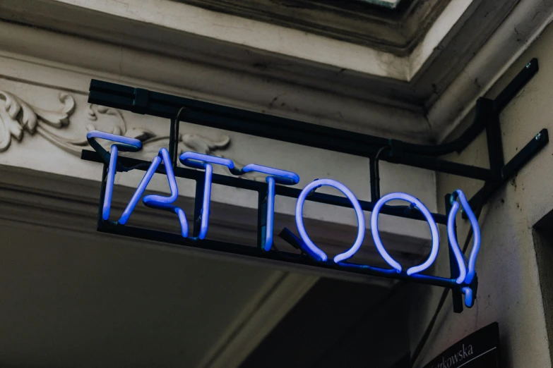 a blue neon sign hanging from the side of a building, a tattoo, trending on pexels, body modification, shop front, tatto, healthcare