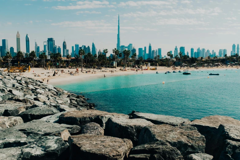 a view of a beach with a city in the background, pexels contest winner, gta : dubai, profile image, summertime, vibrant aesthetic