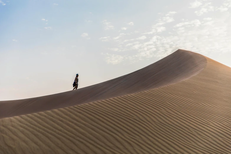 a person standing on top of a sand dune, people walking around, mogul khan, songlines, lpoty