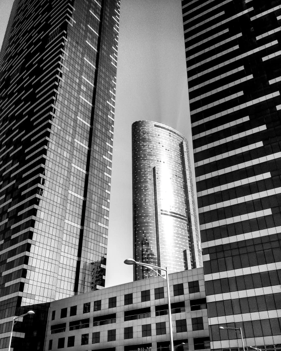 a couple of tall buildings sitting next to each other, a black and white photo, by Michalis Oikonomou, square, golden towers, modern photo, postprocessed)