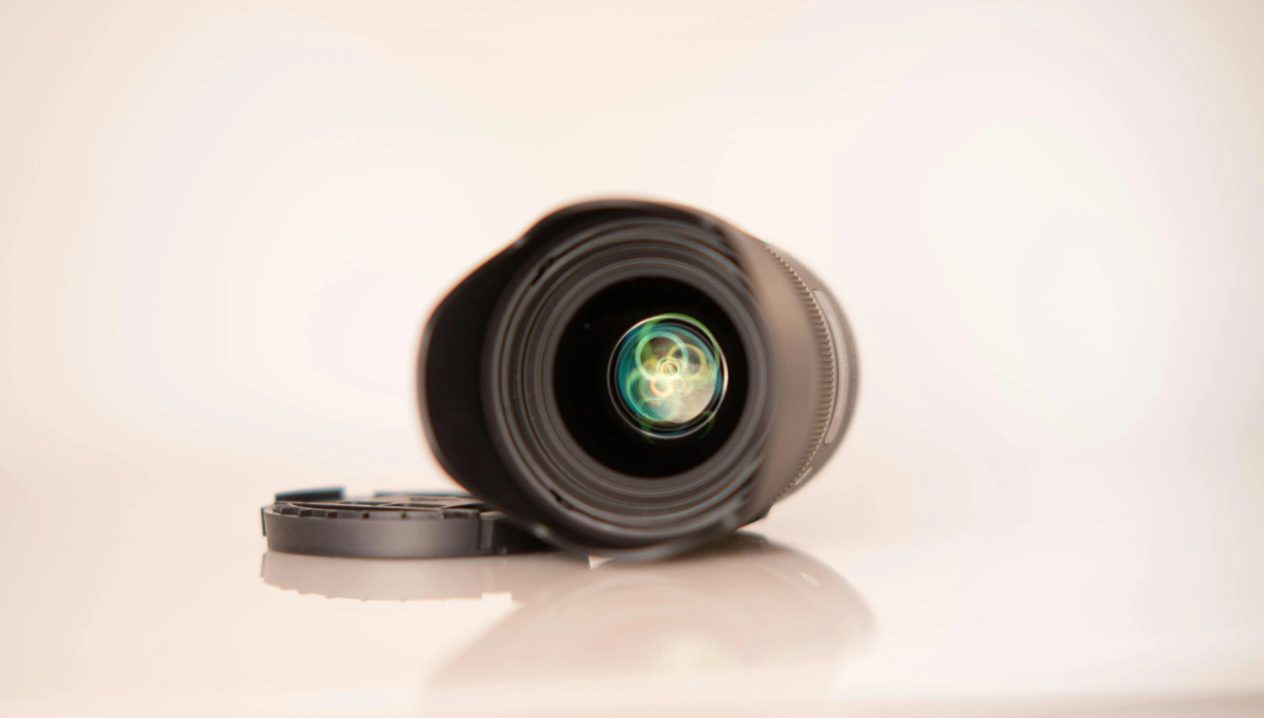 a close up of a camera lens on a table, a macro photograph, unsplash, photorealism, high key detailed, 4k product shot, curled perspective, wide angle lens glow in the dark