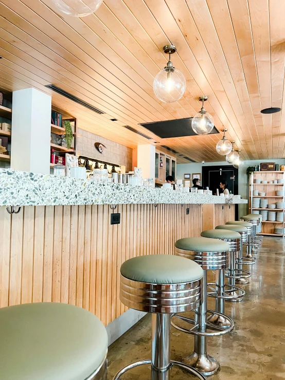 a row of stools sitting in front of a counter, terrazzo, oceanside, thumbnail, cozy