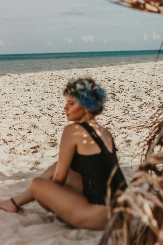 a woman sitting on top of a sandy beach, a colorized photo, pexels contest winner, blue braided hair, trending on vsco, bahamas, beautiful tan mexican woman