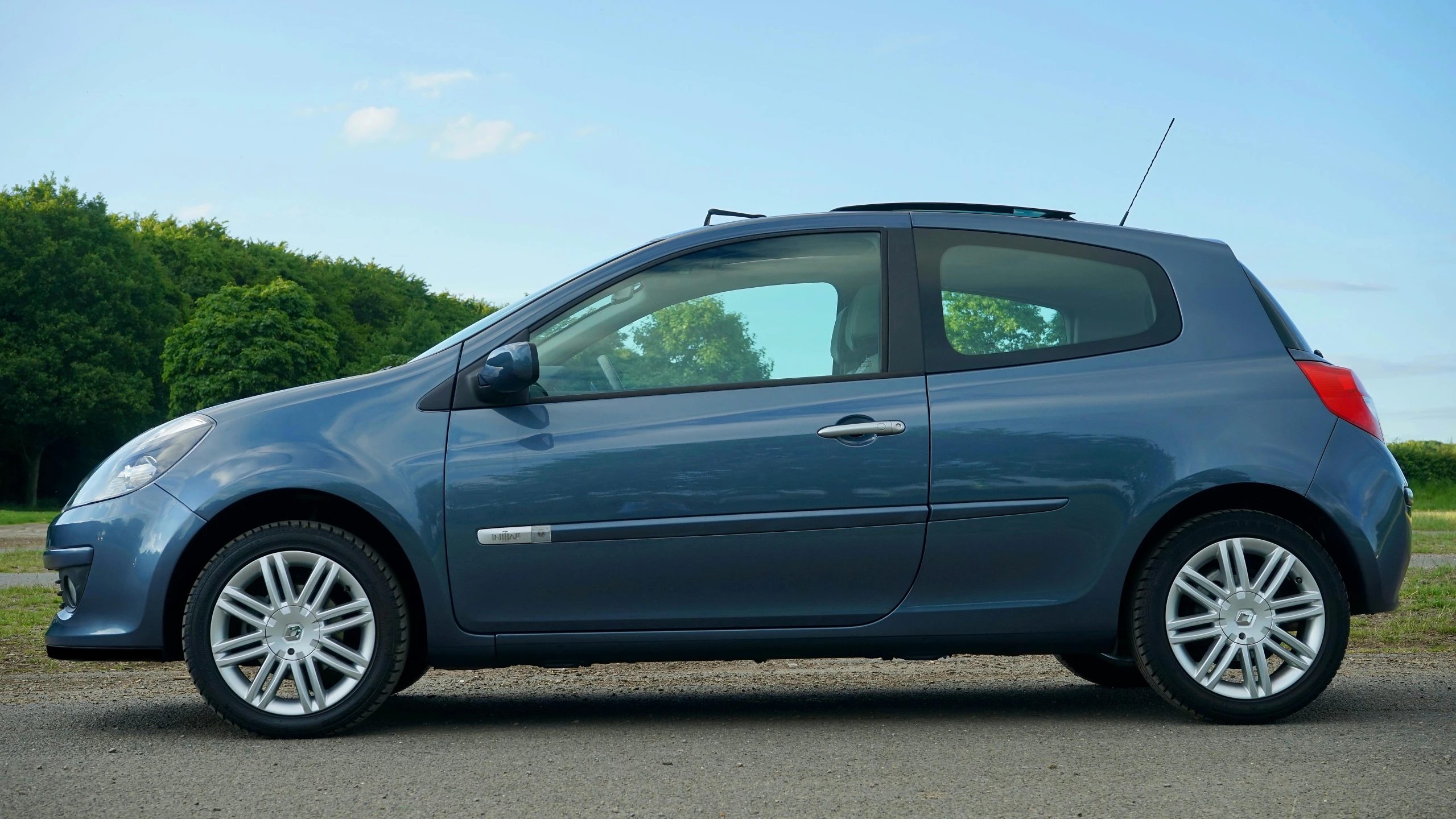 a small blue car parked on the side of the road, renault ultimo, taken in the late 2010s, full body image, 2263539546]