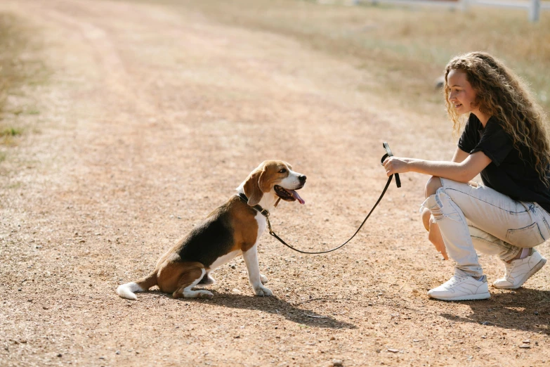 a woman kneeling down with a dog on a leash, by Emma Andijewska, pexels contest winner, cute beagle, on a hot australian day, thumbnail, small in size