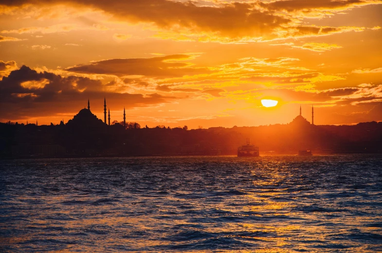 the sun is setting over a body of water, pexels contest winner, hurufiyya, turkish and russian, skyline, slide show, heat shimmering