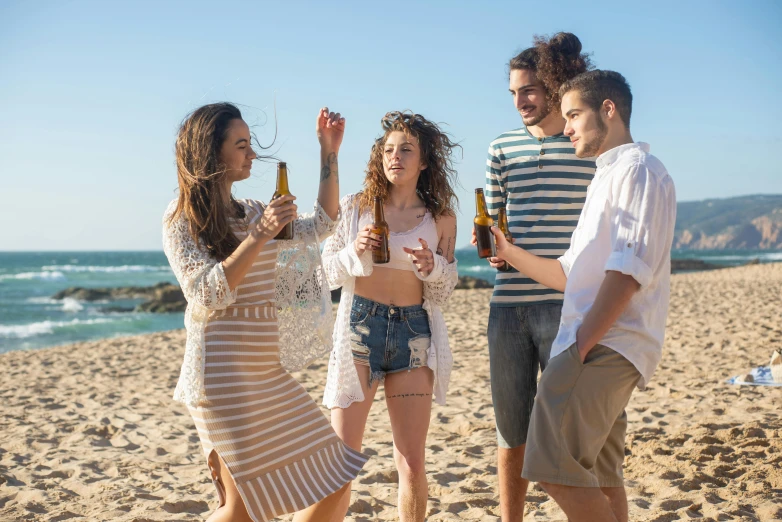 a group of people standing on top of a sandy beach, holding a beer, profile image, playing at the beach, modelling