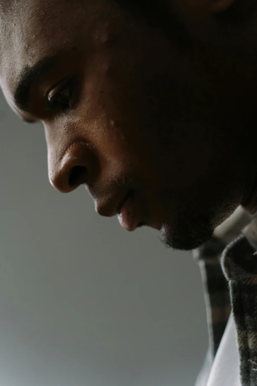 a close up of a person looking at a cell phone, jemal shabazz, looking down, in a quiet moment, head turned