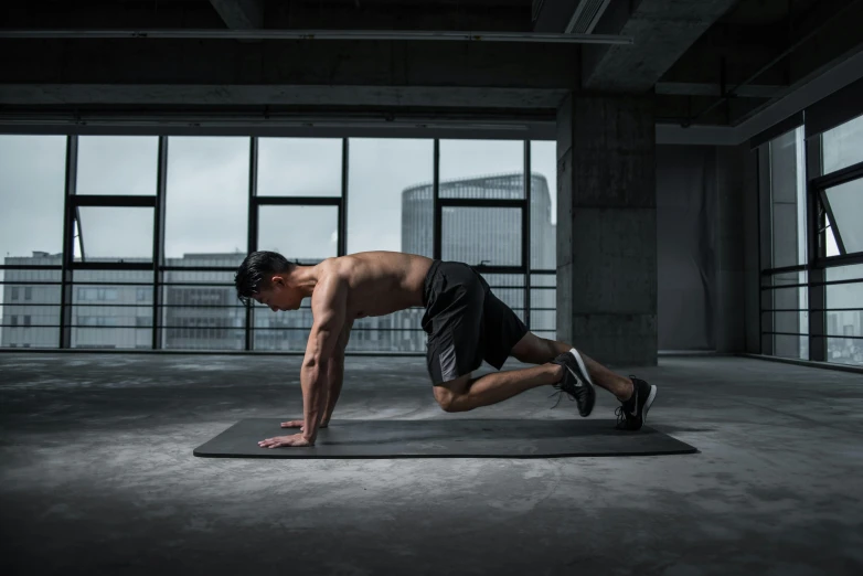 a man doing push ups on a yoga mat, a photo, pexels contest winner, figuration libre, asian male, ad image