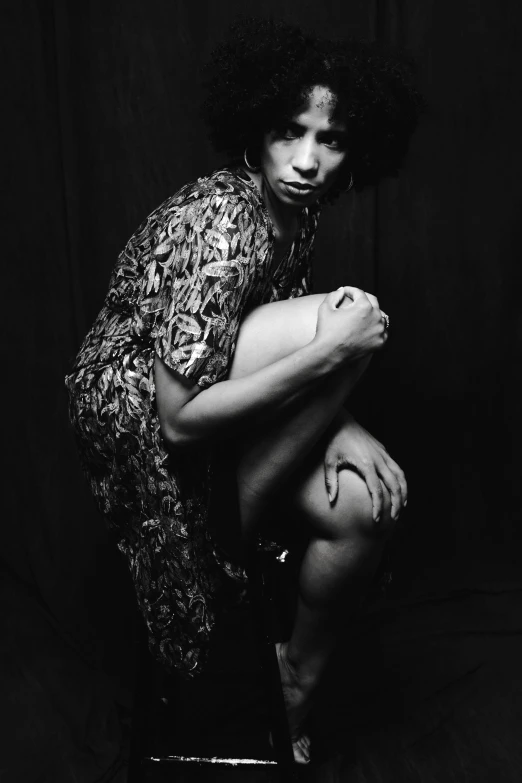 a black and white photo of a woman sitting on a stool, a black and white photo, by Clifford Ross, ashteroth, finn wolfhard, cavewoman, ((portrait))