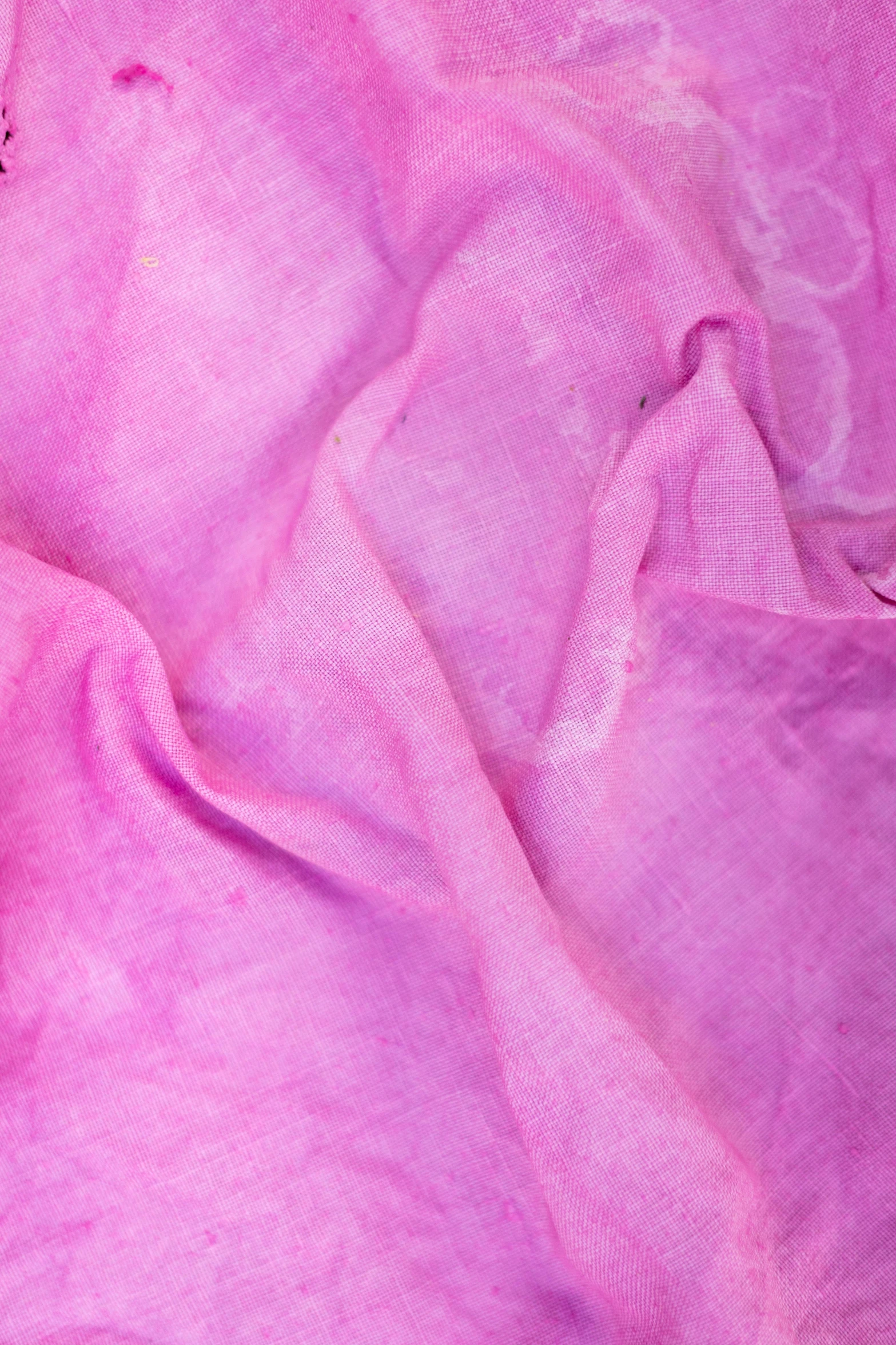 a teddy bear laying on top of a pink blanket, diaphanous iridescent silks, up close, cotton fabric, zoomed in