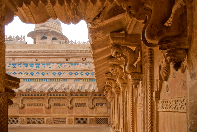 an archway leading to a building with a clock tower in the background, inspired by Frederick Goodall, pexels contest winner, renaissance, painting of mehrangarh fort, detailed carved ornaments, brown, posing