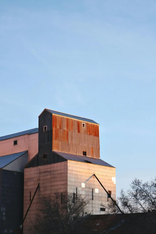 a large grain silo sitting on top of a hill, a portrait, by David Simpson, trending on unsplash, modernism, copper, a wooden, museum setting, minneapolis