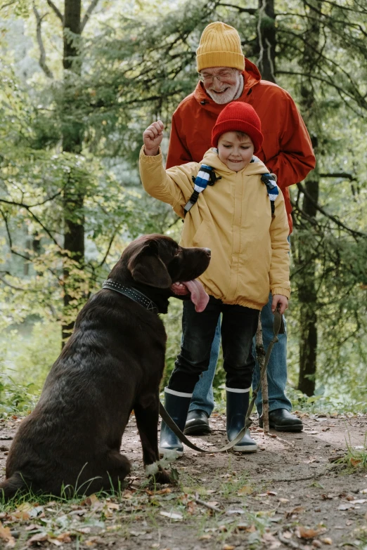 a couple of people and a dog in the woods, with a kid, best practice, ready, brown