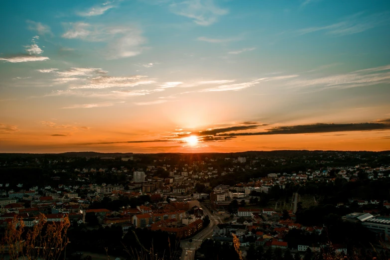 a view of the sun setting over a city, pexels contest winner, gradins view, summer evening, wide views, overlooking