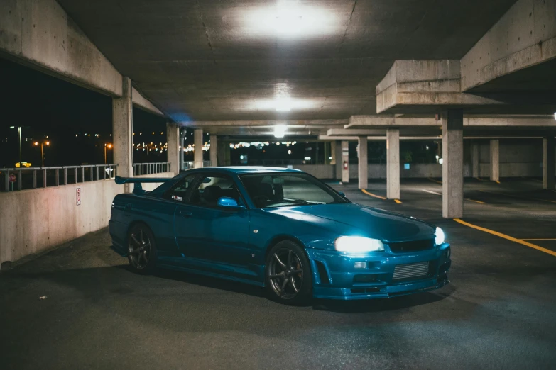a blue car parked in a parking garage, inspired by Elsa Bleda, pexels contest winner, hyperrealism, in a modified nissan skyline r34, ✨🕌🌙, on a street race track, avatar image