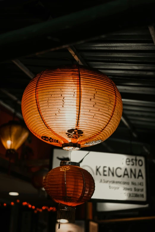 a couple of lanterns hanging from the ceiling, inspired by Kanō Hōgai, trending on unsplash, 8k octan advertising photo, taken on a 2000s camera, brown, kenopsia