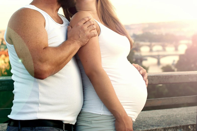 a man and a woman standing next to each other, a photo, pexels contest winner, happening, membrane pregnancy sac, australian, beautifully soft lit, - photorealistic