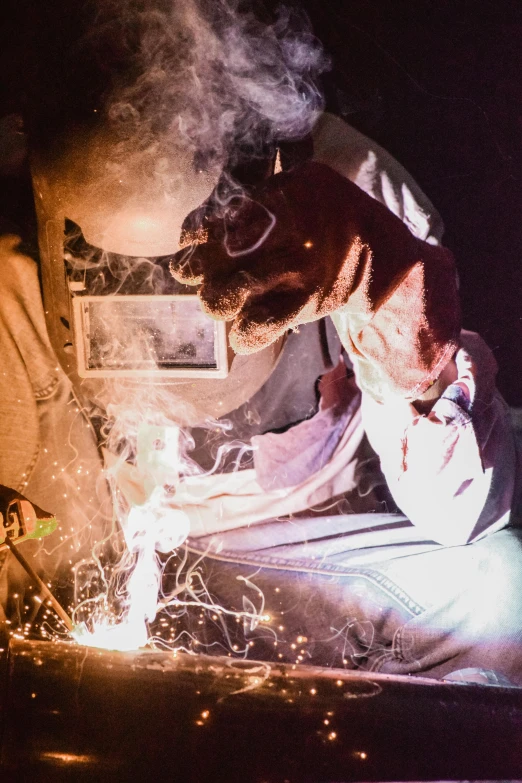 a welder working on a piece of metal, a portrait, pexels contest winner, arbeitsrat für kunst, smoking a bowl of hash together, fuming effigy, pastel', grainy