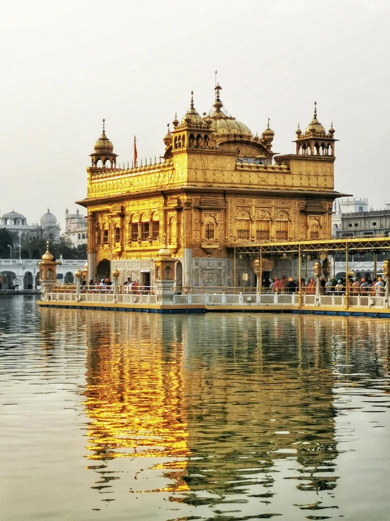 the golden temple is reflected in the water, by Julia Pishtar, square, panoramic shot, lgbtq, eye level