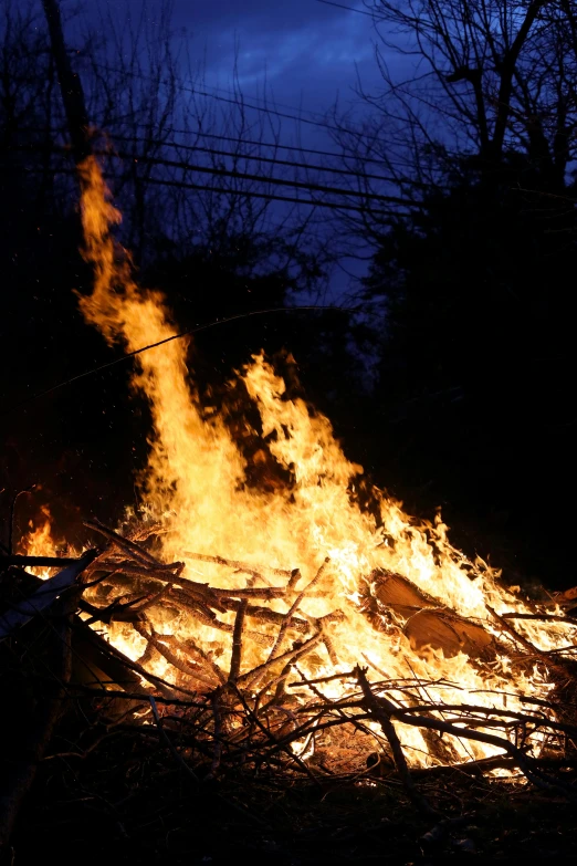 a man that is standing in front of a fire, flickr, ap news photograph, closeup photo, multiple stories, outdoor photo