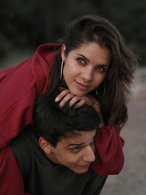 a man carrying a woman on his back, trending on unsplash, black haired girl wearing hoodie, dafne keen, low quality photo, lovingly looking at camera