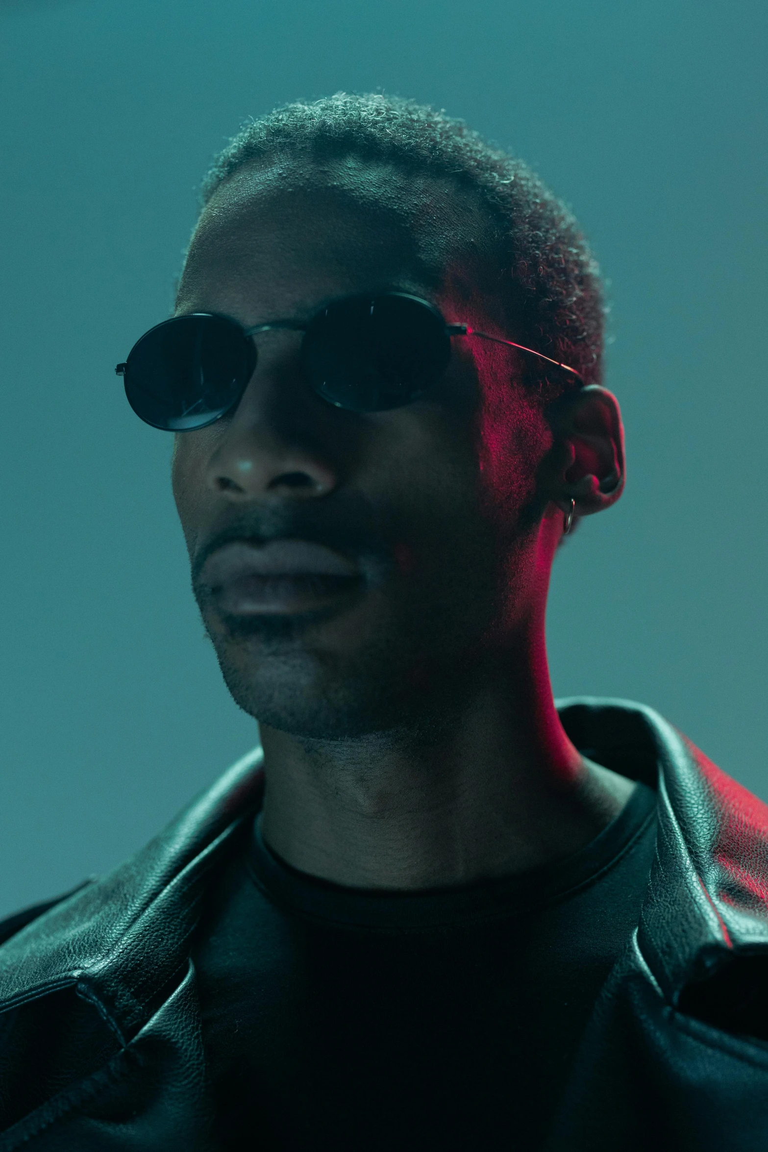 a man in a leather jacket and sunglasses, an album cover, inspired by Terrell James, trending on pexels, photorealism, real-life brook, altered carbon series, he wears an eyepatch, perfectly lit. movie still