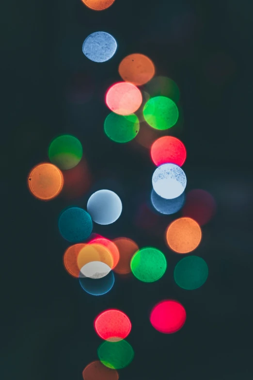 a bunch of lights that are in the dark, pexels, light and space, colored dots, holiday season, paul barson, holiday vibe