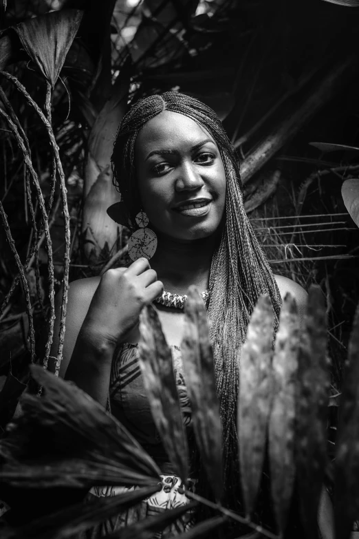 a black and white photo of a woman surrounded by plants, a black and white photo, by Felix-Kelly, afrofuturism, with a beautifull smile, long black braids, taken in zoo, on jungle night !!!