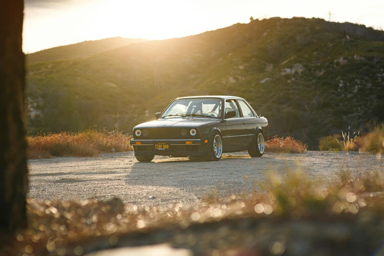 a car is parked on the side of the road, a portrait, by Drew Tucker, unsplash contest winner, renaissance, bmw e 3 0, golden hour”, malibu canyon, he is a long boi ”