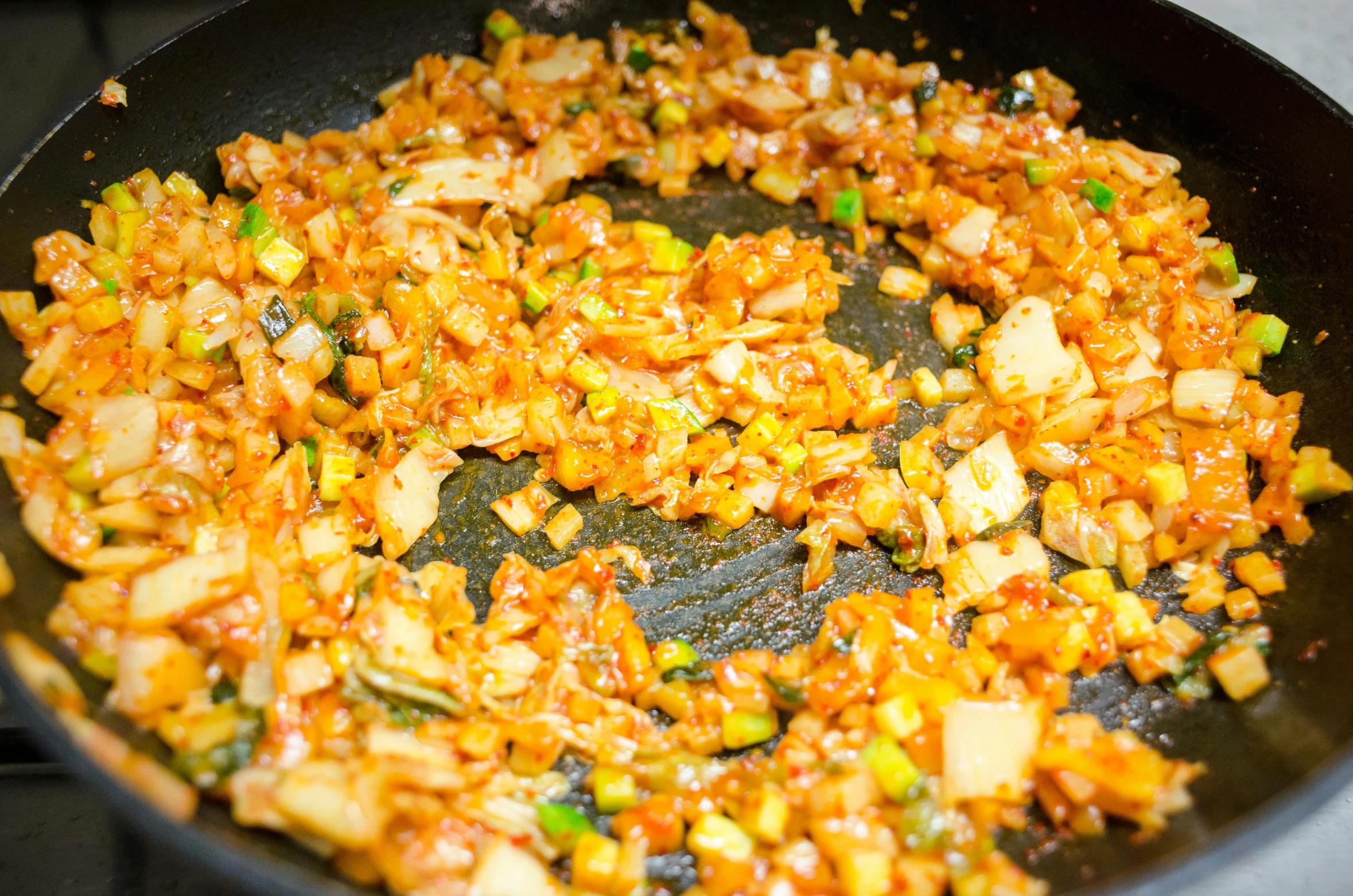 a frying pan filled with food sitting on top of a stove, inspired by Carpoforo Tencalla, extra onions and ketchup, mineral grains, reggae, brocade