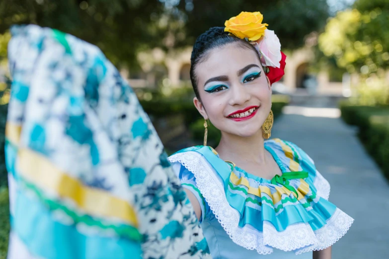 a woman in a blue dress with a flower in her hair, pexels contest winner, happening, folklorico, avatar image, university, various posed