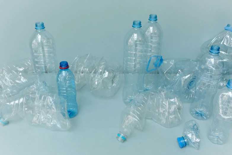 a group of plastic bottles sitting on top of a table, by Matija Jama, plasticien, plain background, light-blue, pbr materials, illegible