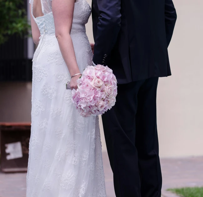 a bride and groom standing next to each other, by Gwen Barnard, unsplash, romanticism, taken in the late 2010s, bouquet, the dress\'s lower, white and pink