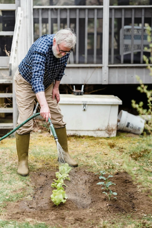 a man that is standing in the dirt with a shovel, home and garden, lynn skordal, pouring, profile image