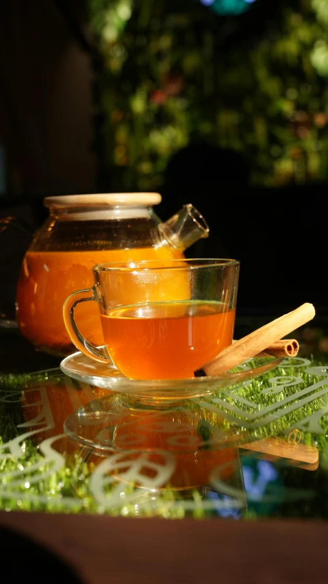 a cup of tea sitting on top of a glass table, pexels, renaissance, assam tea village background, square, honey, cinnamon