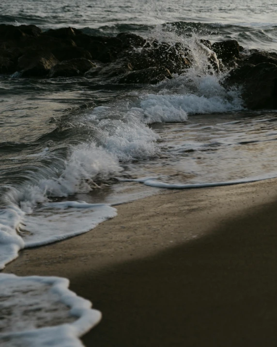 a man riding a surfboard on top of a sandy beach, pexels contest winner, renaissance, waves crashing at rocks, late evening, photo of the middle of the ocean, slightly pixelated