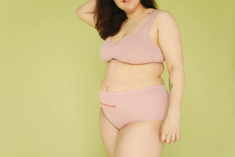 a woman in a pink underwear posing for a picture, slightly overweight, cynthwave, understated aesthetic, not cropped