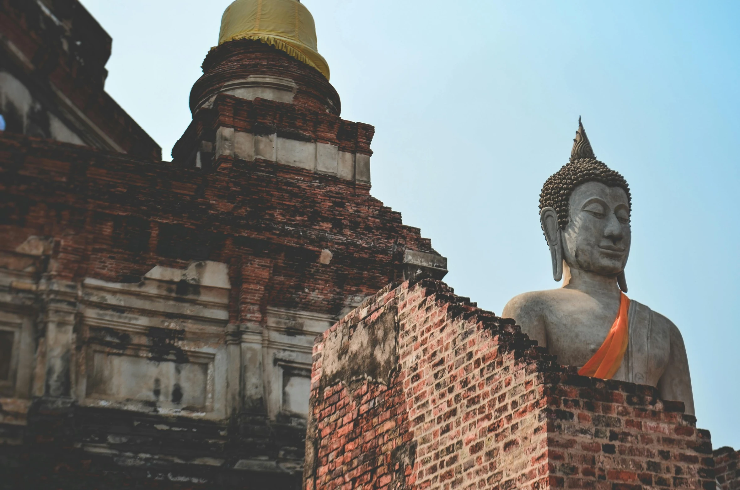 a buddha statue sitting on top of a brick building, by Carey Morris, pexels contest winner, thai, background image, historic photo, thumbnail