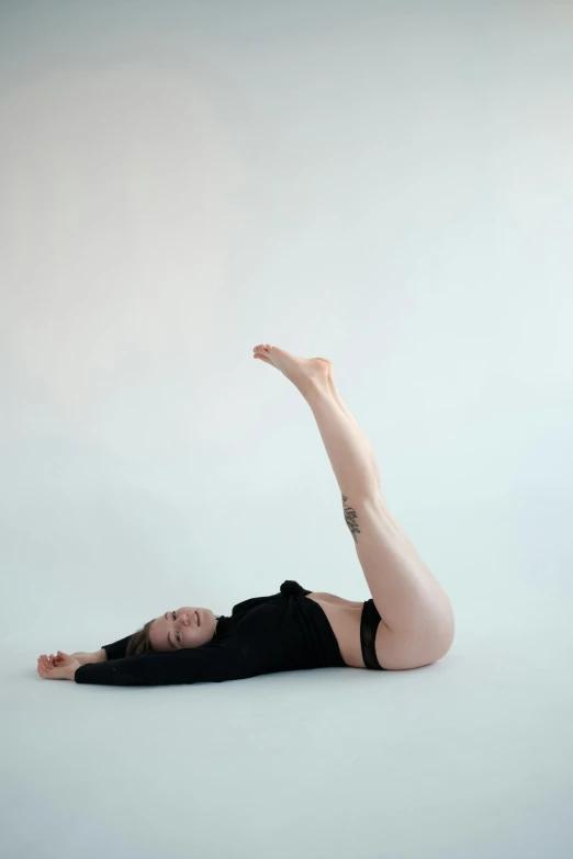 a woman in a black leo leo leo leo leo leo leo leo leo leo leo leo leo, a picture, unsplash, arabesque, laying on her back, a pale skin, slightly minimal, 2 arms and 2 legs