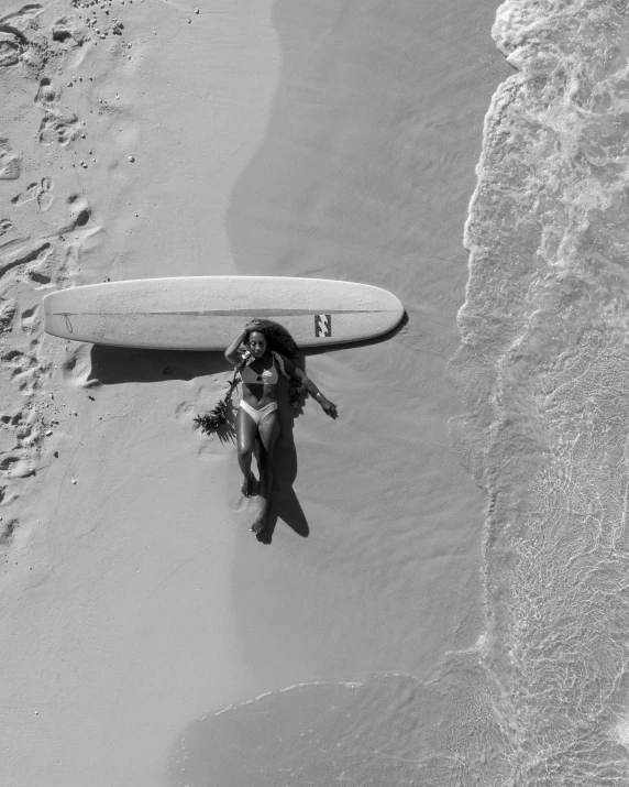 a person laying on a beach with a surfboard, a black and white photo, unsplash contest winner, smiling down from above, centered full body, fernanda suarez, hot sun from above