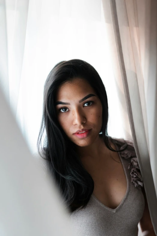 a woman standing behind a curtain in front of a window, by Sebastian Vrancx, unsplash, gorgeous latina face, pharah, on grey background, mai anh tran