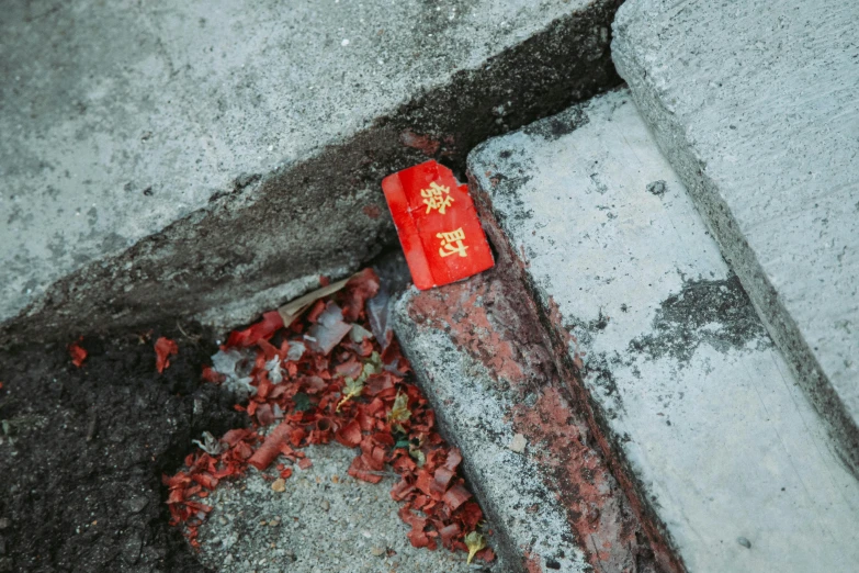 a red fire hydrant sitting on the side of a road, an album cover, by Elsa Bleda, pexels contest winner, auto-destructive art, chinese new year in shanghai, brick debris, rectangle, close up shot of an amulet