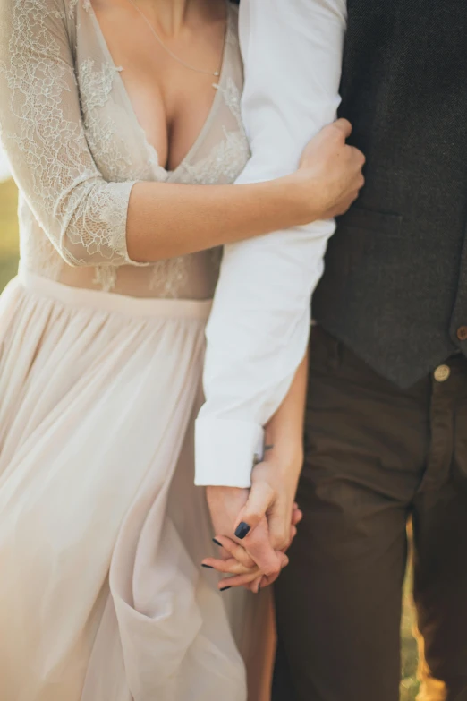 a man and a woman holding hands in a field, an album cover, by Adam Marczyński, unsplash, romanticism, delicate soft hazy lighting, holding arms on holsters, 15081959 21121991 01012000 4k, romantic dress