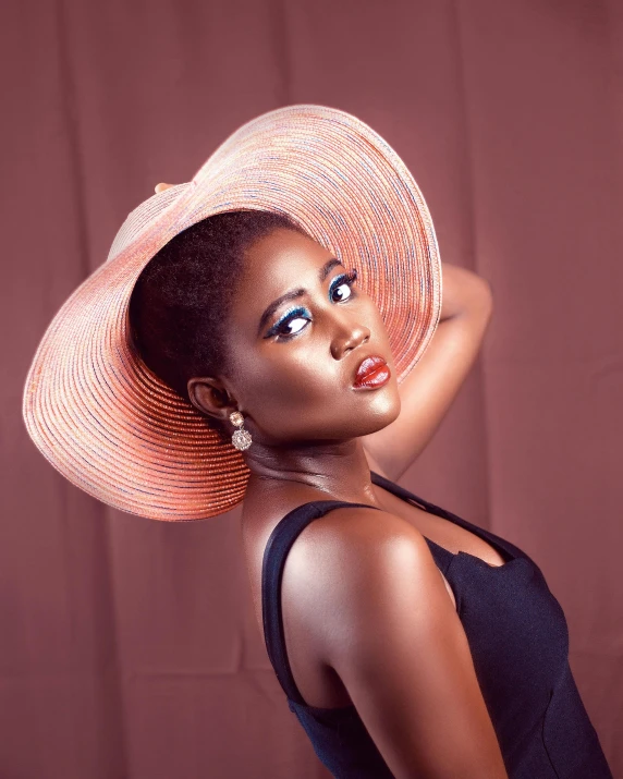 a woman in a hat posing for a picture, by Lily Delissa Joseph, brown skin. light makeup, thumbnail, coral lipstick, vouge style photo