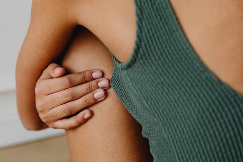 a close up of a person holding the arm of a woman, flat chested, bumps, relaxed pose, manuka