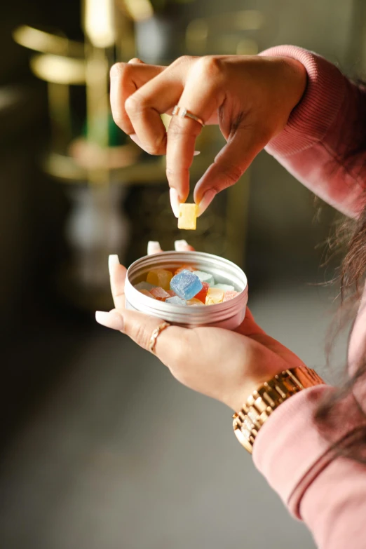 a close up of a person holding a jar of food, trinkets, mdma, made of high tech materials, ameera al-taweel